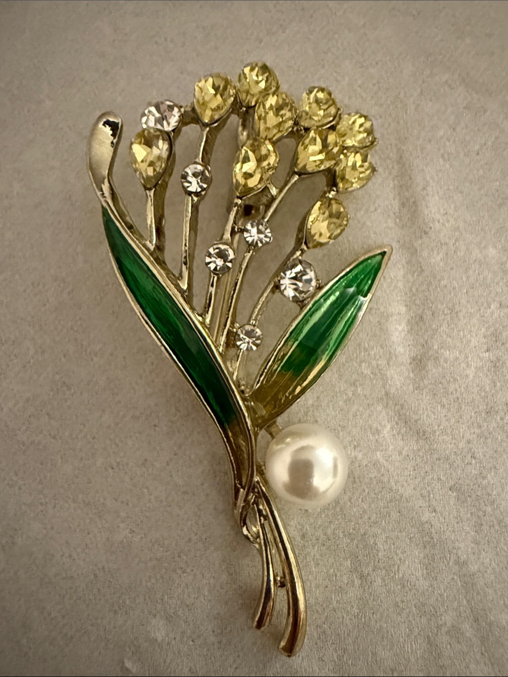 Elegant Gold Floral Pearl Brooch with Yellow Crystals and Green Enamel Leaves